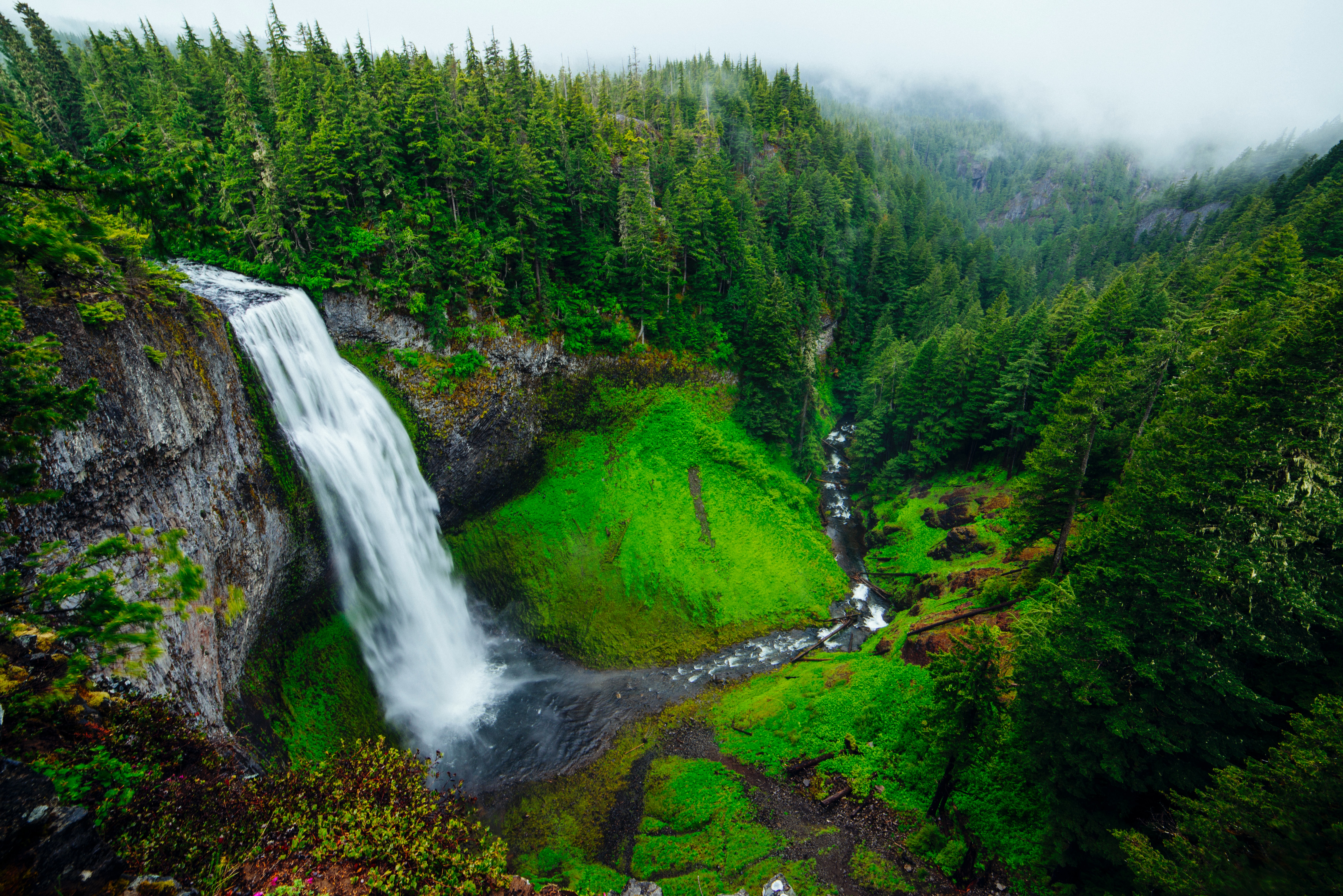 Waterfall cascading into a lush green valley