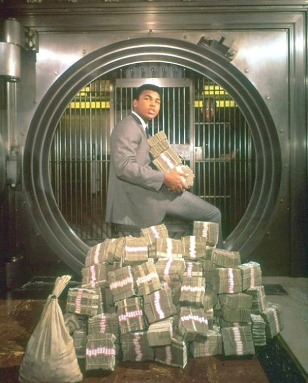 Muhammad Ali in a bank vault with cash