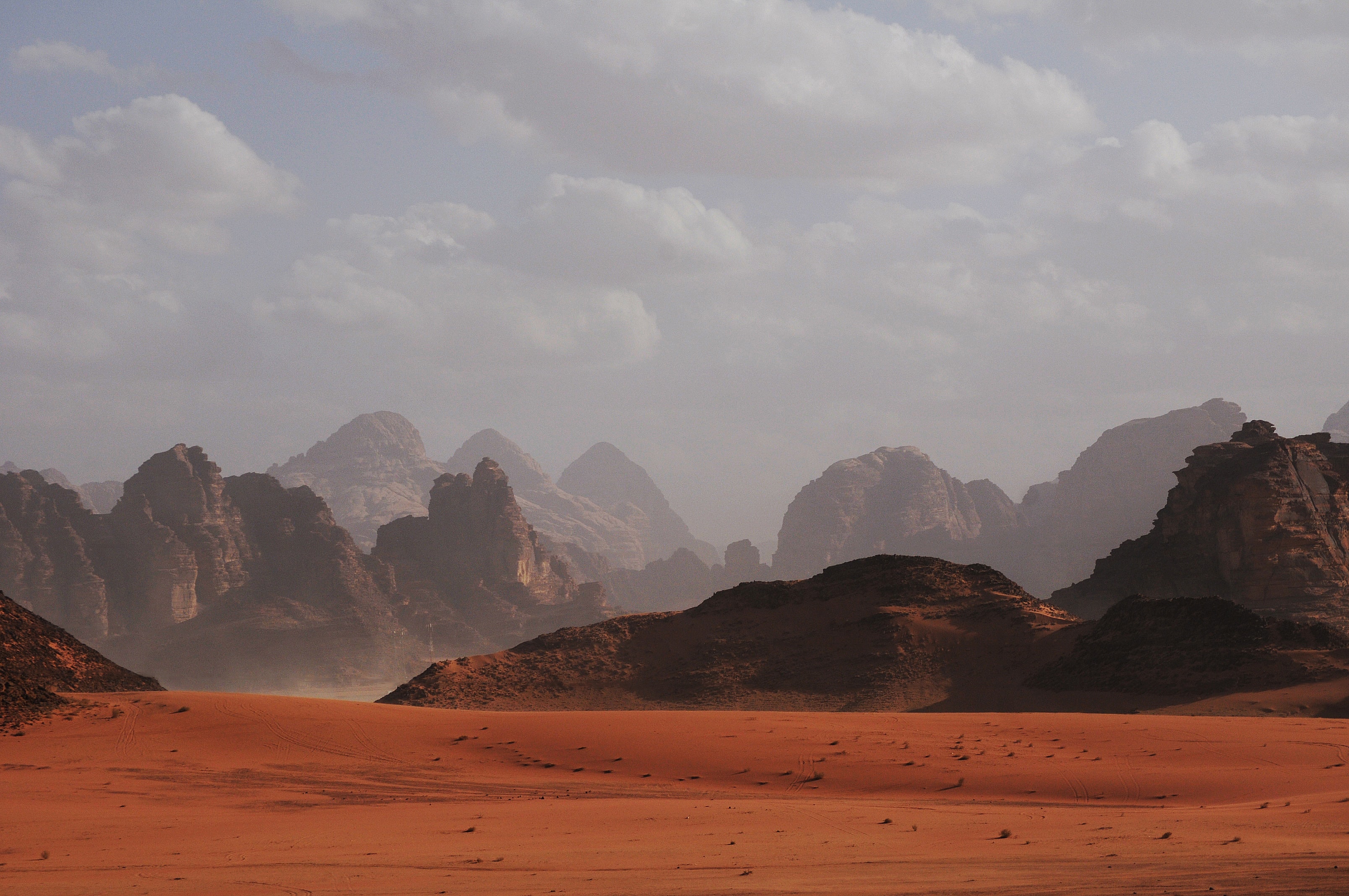 Wadi Rum desert with red sand and jagged mountains