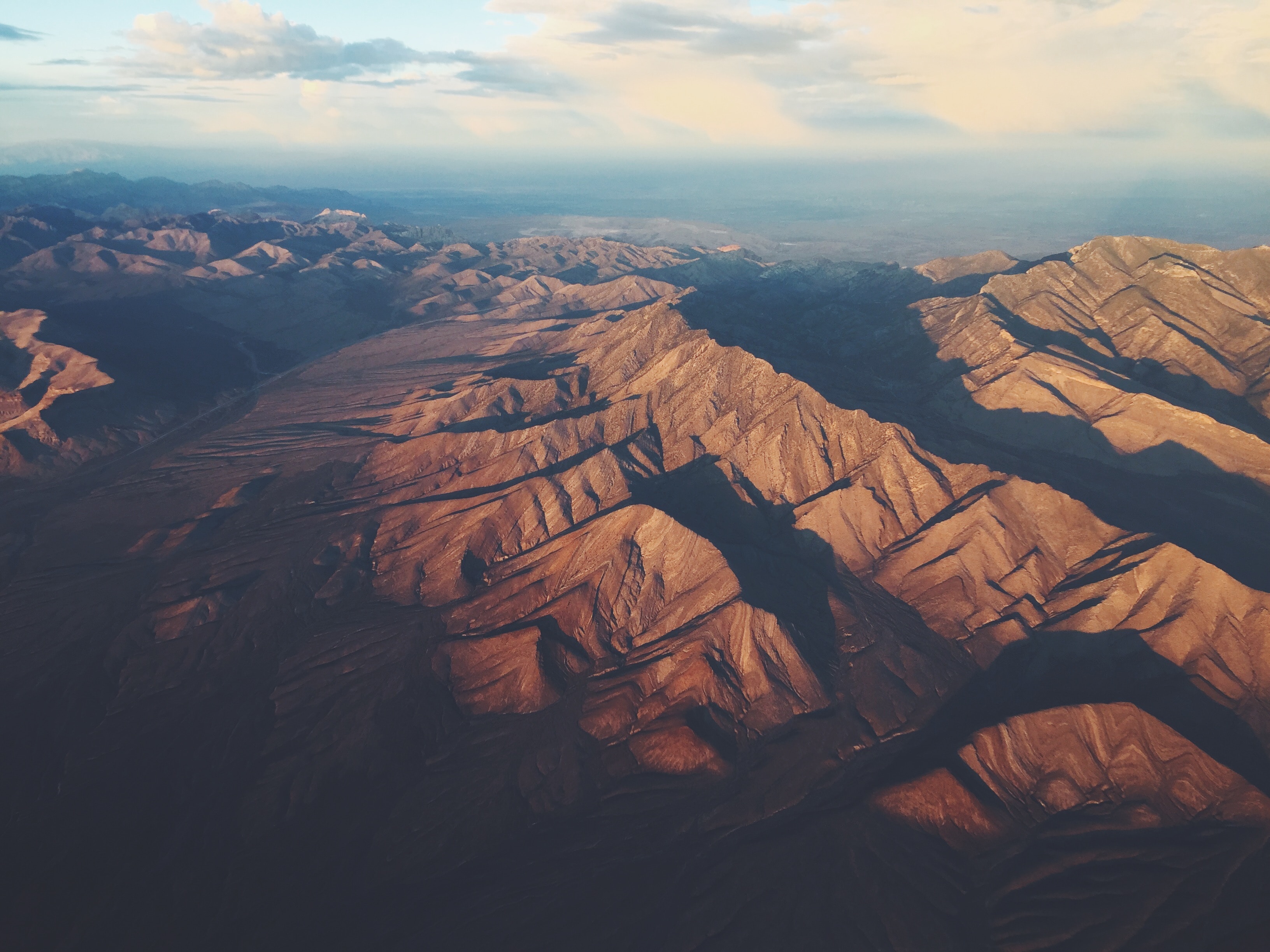 Aerial view of mountain ridges at golden hour