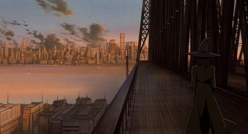 A solitary figure on a steel truss bridge looks out over a dense city skyline at sunset