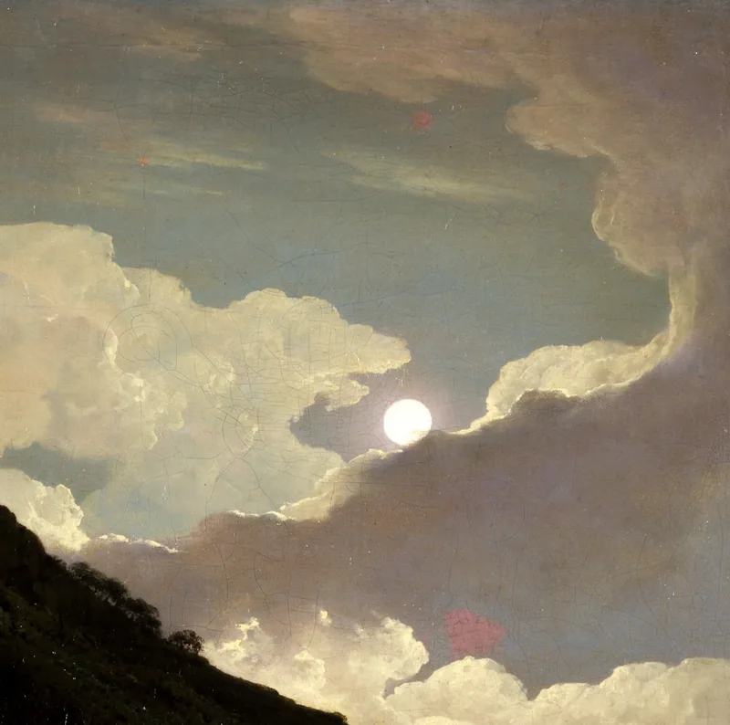 A full moon shines through a rift in towering banks of cloud above a dark hillside