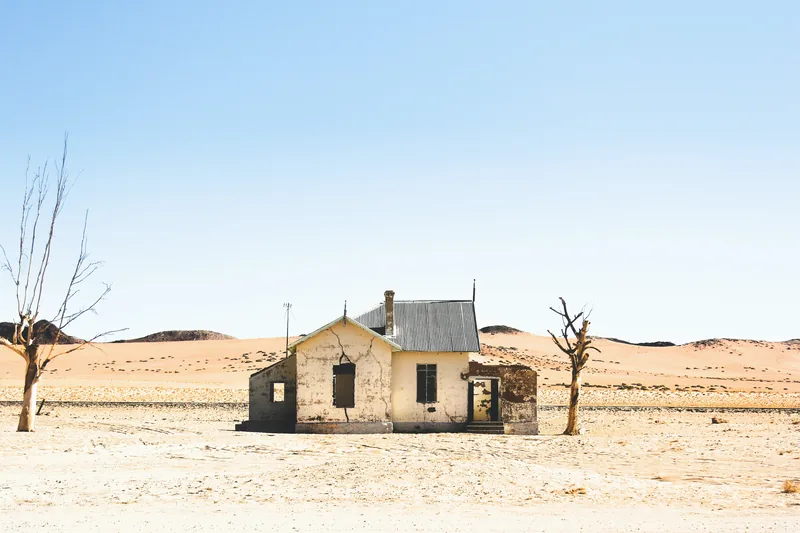 Abandoned house in a barren desert landscape